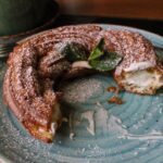 a plate with a half eaten pastry on it