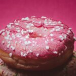 three donuts with pink frosting and sprinkles