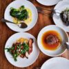 Four plates of delicious food arranged on a table.
