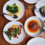 Four plates of delicious food arranged on a table.