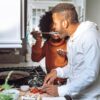 man in white and orange long sleeve shirt holding chopsticks