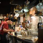 man cooking inside kitchen