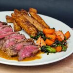 cooked meat with green vegetable on white ceramic plate