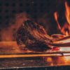 person barbecuing meat