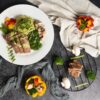 a white plate topped with meat and veggies