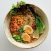 white ceramic bowl with rice and sliced lemon
