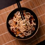 黒い器に盛りつけた細い麺