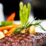 アスパラとにんじんを添えたステーキのクローズアップ